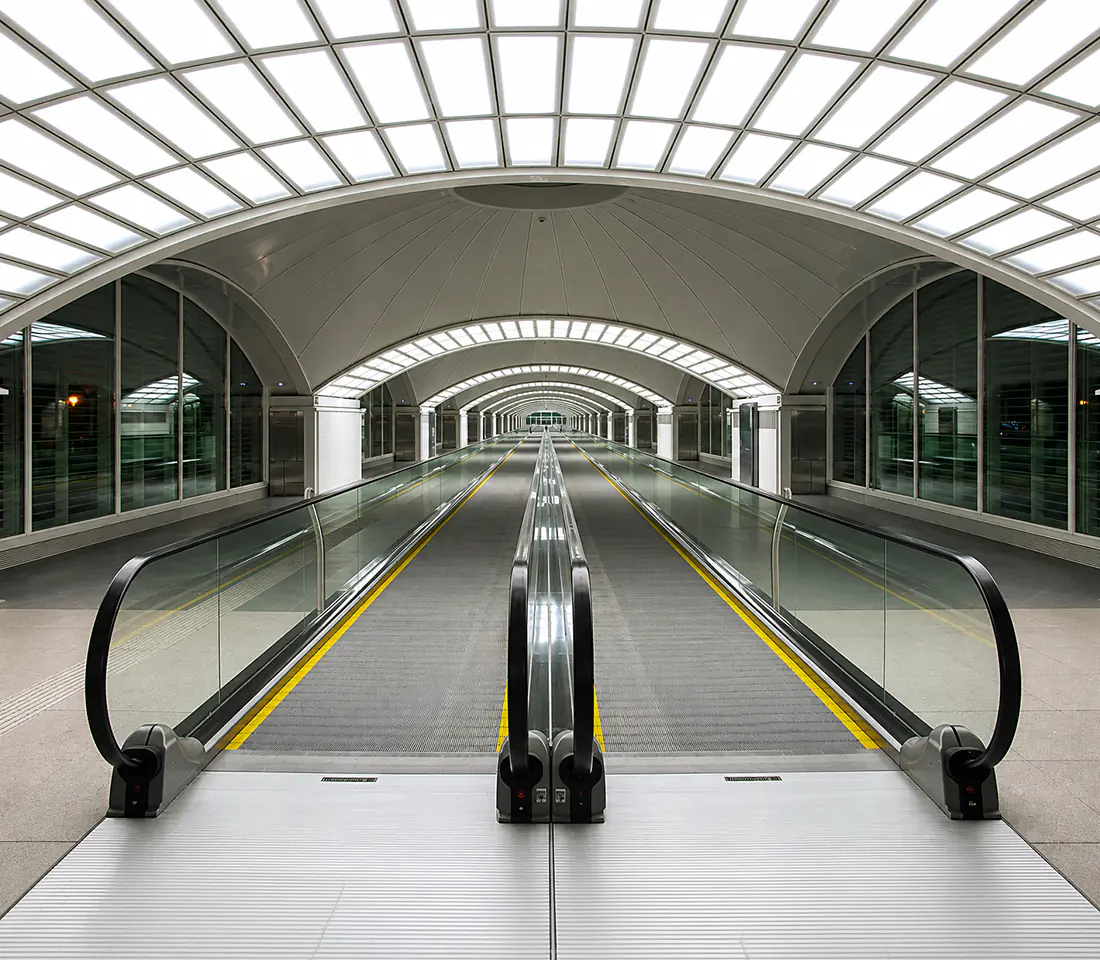 Child travelling with luggage and parents on a GLIDE travelator