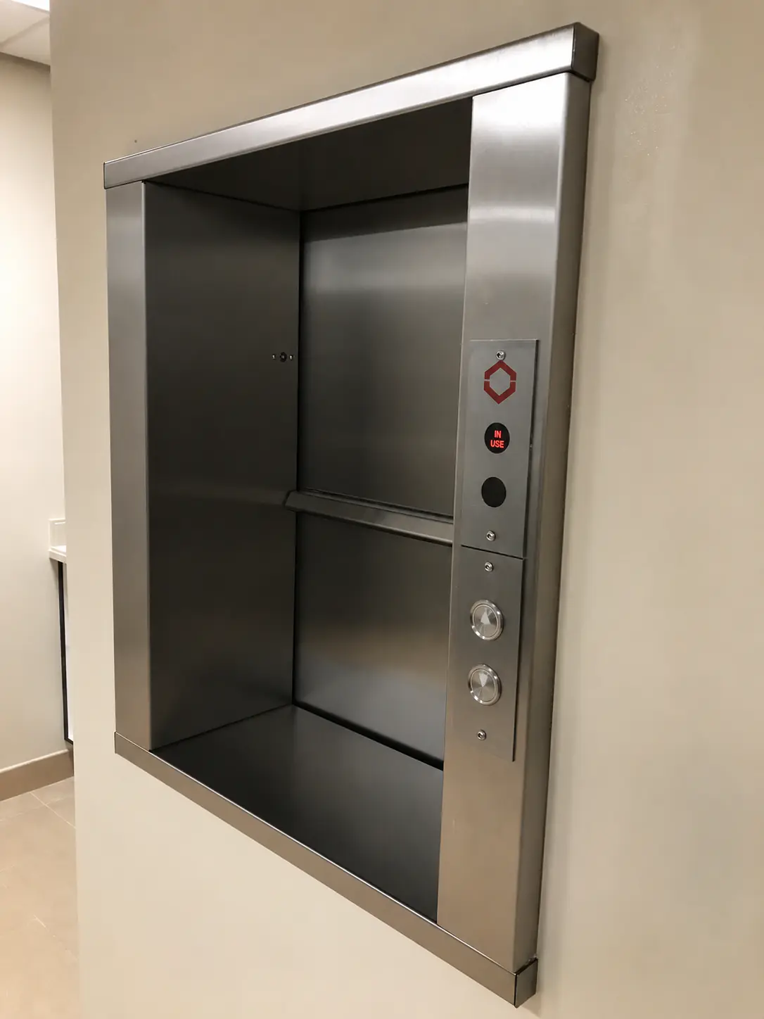Dumbwaiter service lift in motion, brushed stainless interior